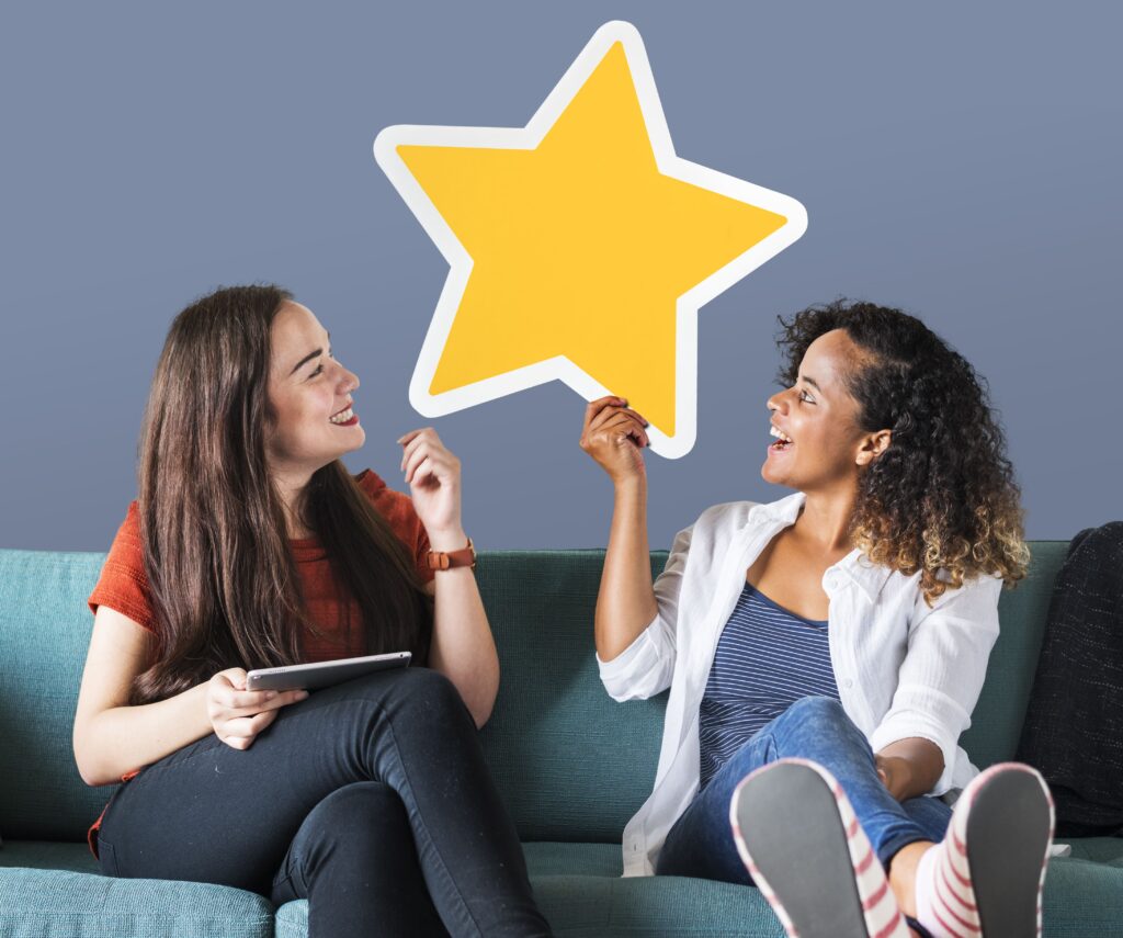 Cheerful women holding a golden star icon as a representation of feedback process