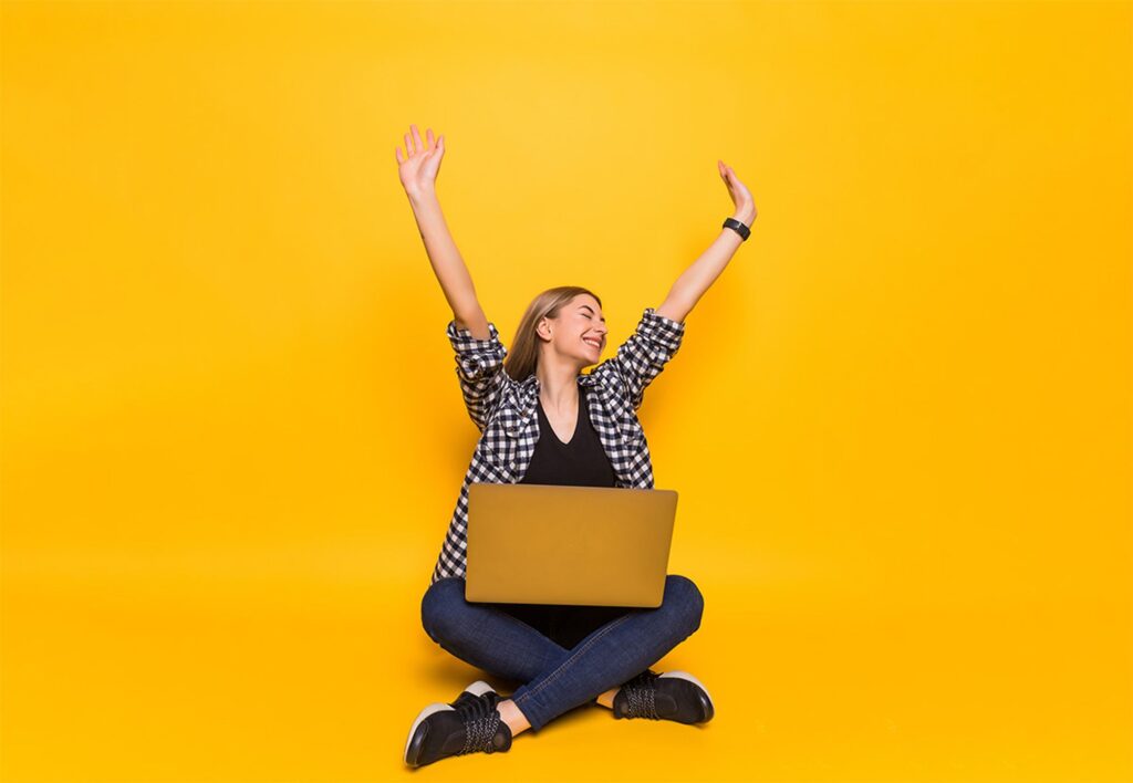 Woman with her laptop representing the joy of successful software engineers